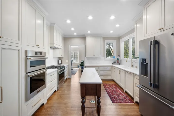 This bright kitchen features ample counter space and modern appliances for culinary endeavors.