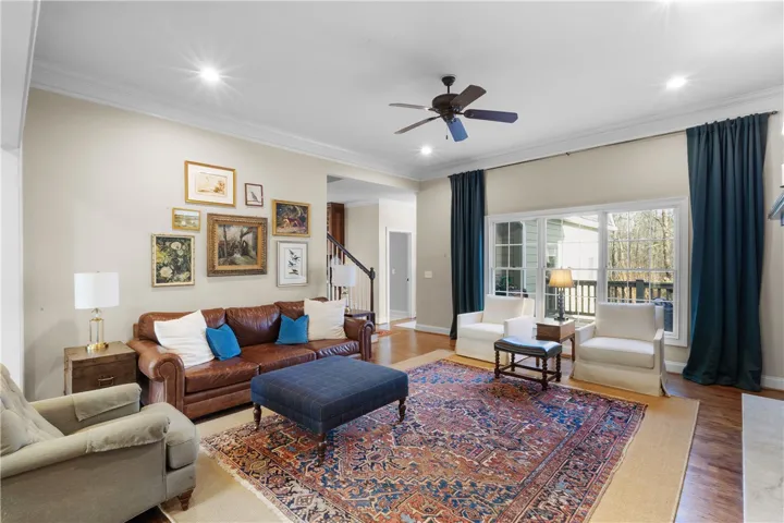 Warm and inviting living space with abundant natural light and rich wood flooring.