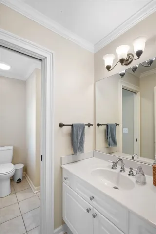 This bright bathroom features a spacious vanity and a convenient separate water closet.