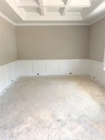 Ornate coffered ceilings and wainscoting elevate this spacious room's appeal.