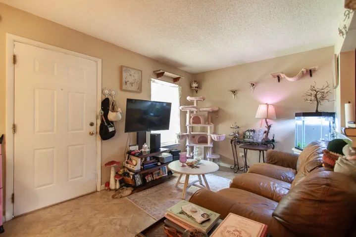 This inviting living room features durable tile flooring, creating a cozy and functional living space.