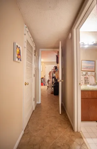 This interior hallway features durable tile flooring, providing a clean and practical walkway.