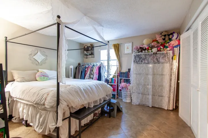 This spacious bedroom features ample natural light and a closet for convenient storage.