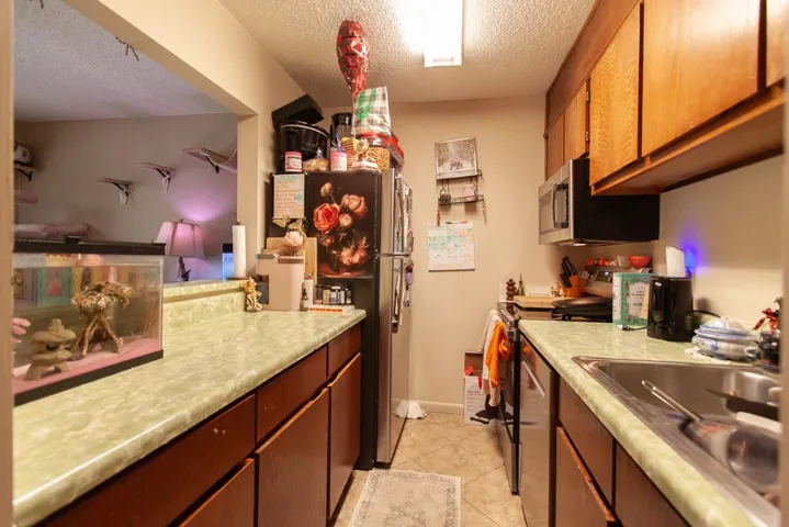 This compact kitchen offers functional workspace with practical amenities.