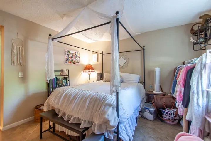 This cozy bedroom features a stylish bed and ample storage space, perfect for comfortable living.