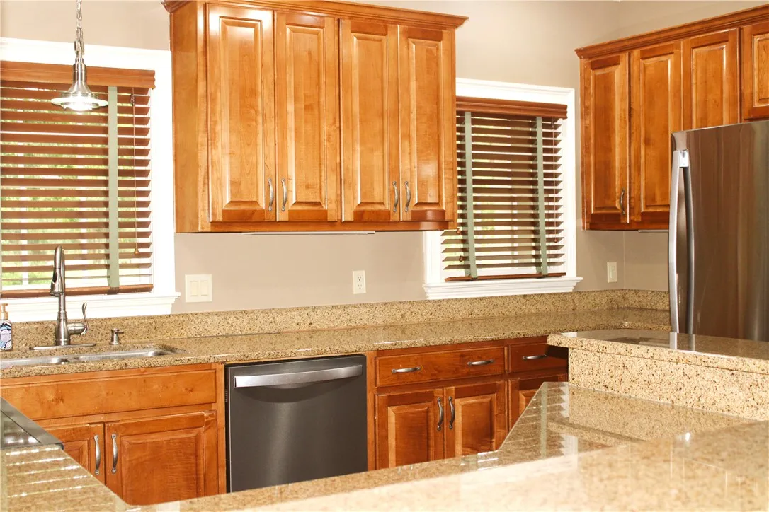 This functional kitchen features ample cabinetry and beautiful countertops, perfect for everyday living.