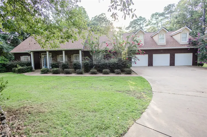 A classic brick-front residence with an attached triple garage and a sweeping driveway welcomes you home.