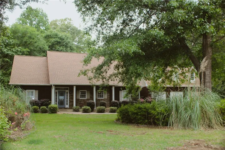 This charming residence features a well-maintained exterior, welcoming you with its classic appeal and lush surroundings.