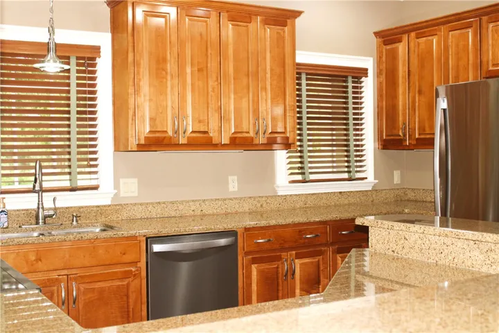 This functional kitchen features ample cabinetry and beautiful countertops, perfect for everyday living.