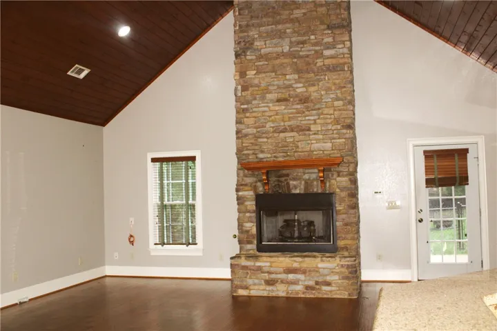 This inviting living space features vaulted ceilings and a floor-to-ceiling stone fireplace.