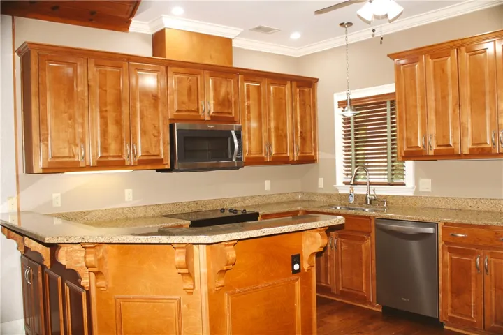 This inviting kitchen offers abundant cabinetry, elegant countertops, and contemporary appliances for everyday living.