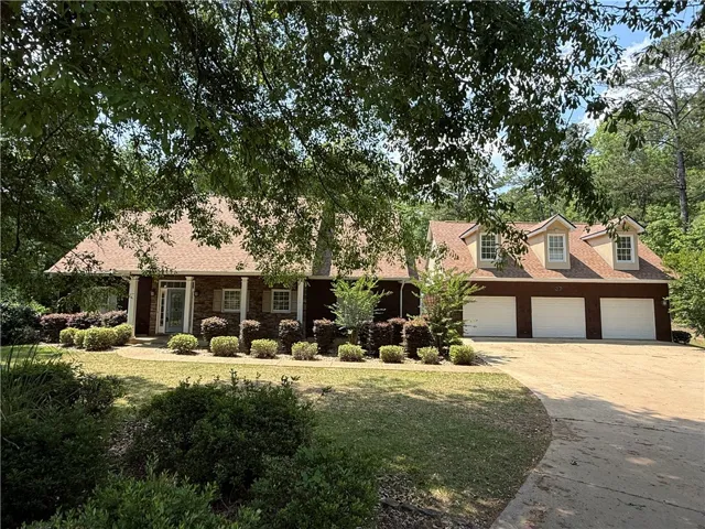 This captivating home boasts a spacious driveway and an inviting front entrance.