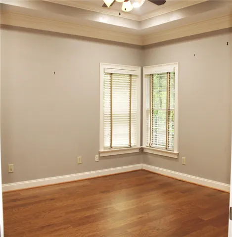 This airy room features rich hardwood flooring and elegant crown molding.