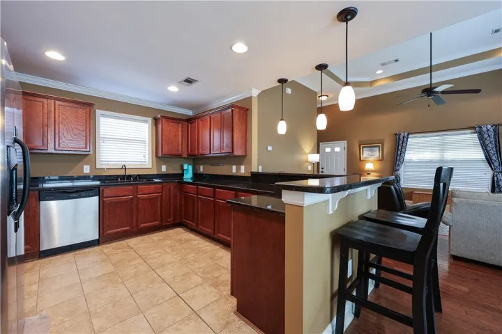 This inviting kitchen with a bar seamlessly connects to the living area.