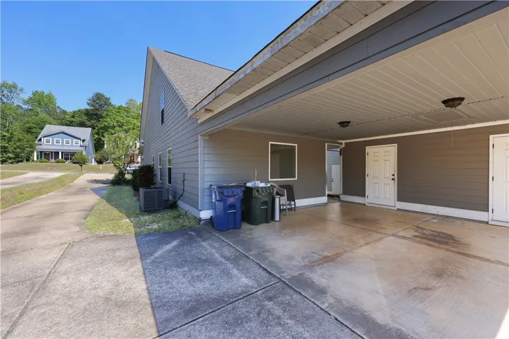 This residence features a large driveway with a convenient carport and 2 outdoor storage closets.