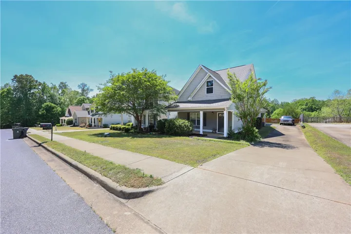 This charming residence offers a welcoming facade with a covered porch.