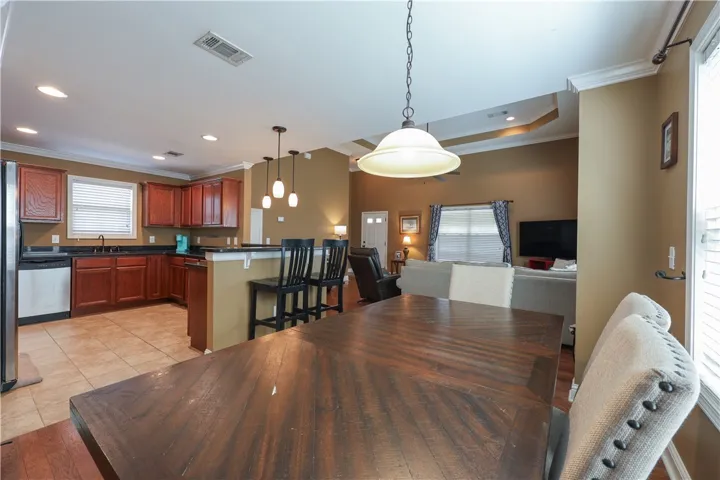 This inviting space combines kitchen, dining, and living areas for seamless daily living and entertaining.