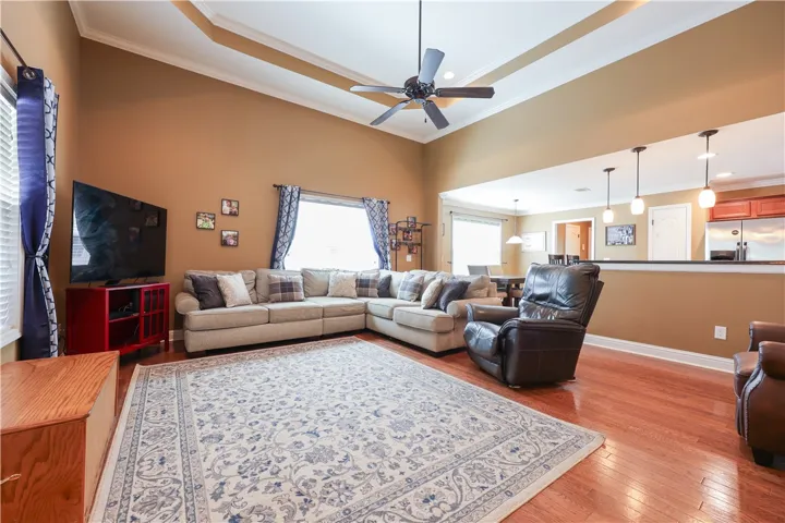 This inviting living area boasts rich hardwood floors and vaulted ceilings, creating an airy, comfortable atmosphere.