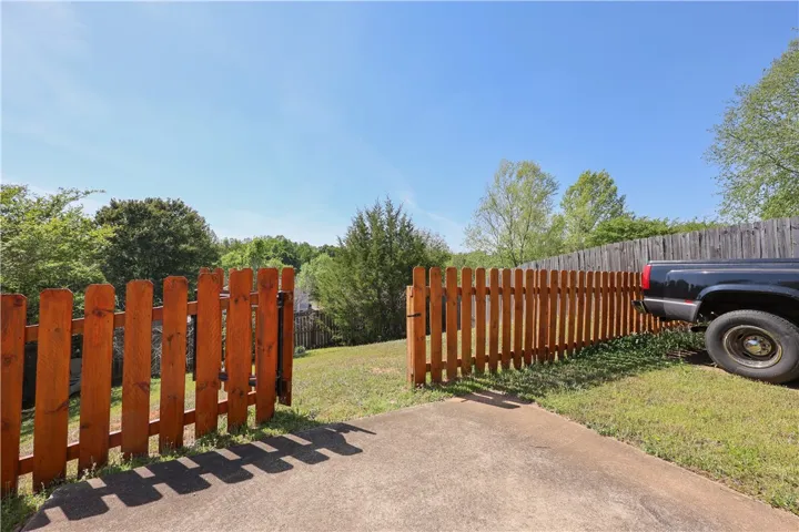 Private yard with wood fencing.