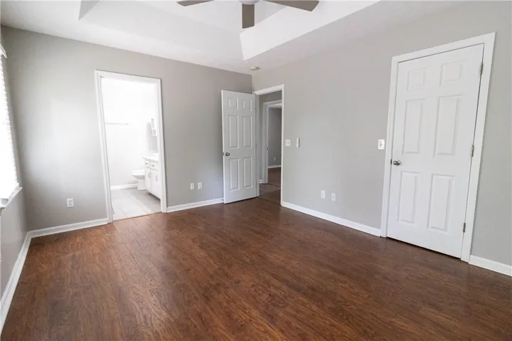 Primary bedroom, featuring a unique tray ceiling and private bath.