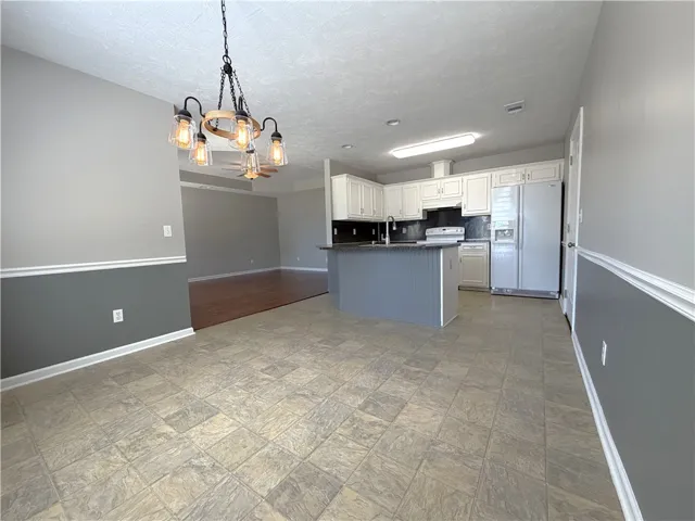 This spacious kitchen and dining area offers functional design and modern comfort for everyday living.