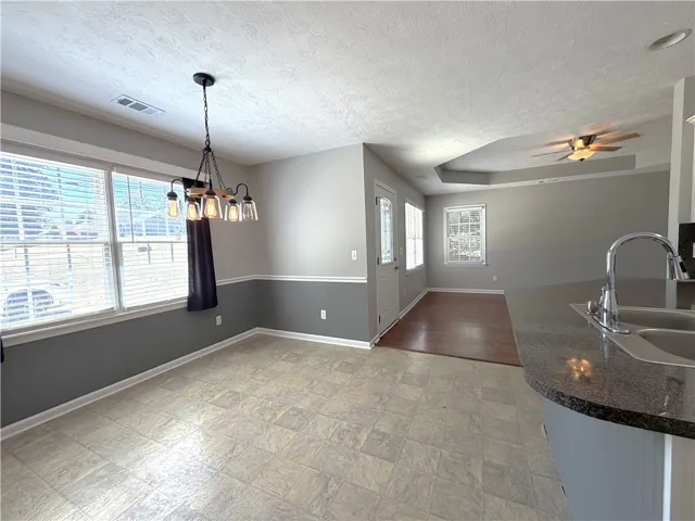 This bright and airy space features a dining area with ample natural light.
