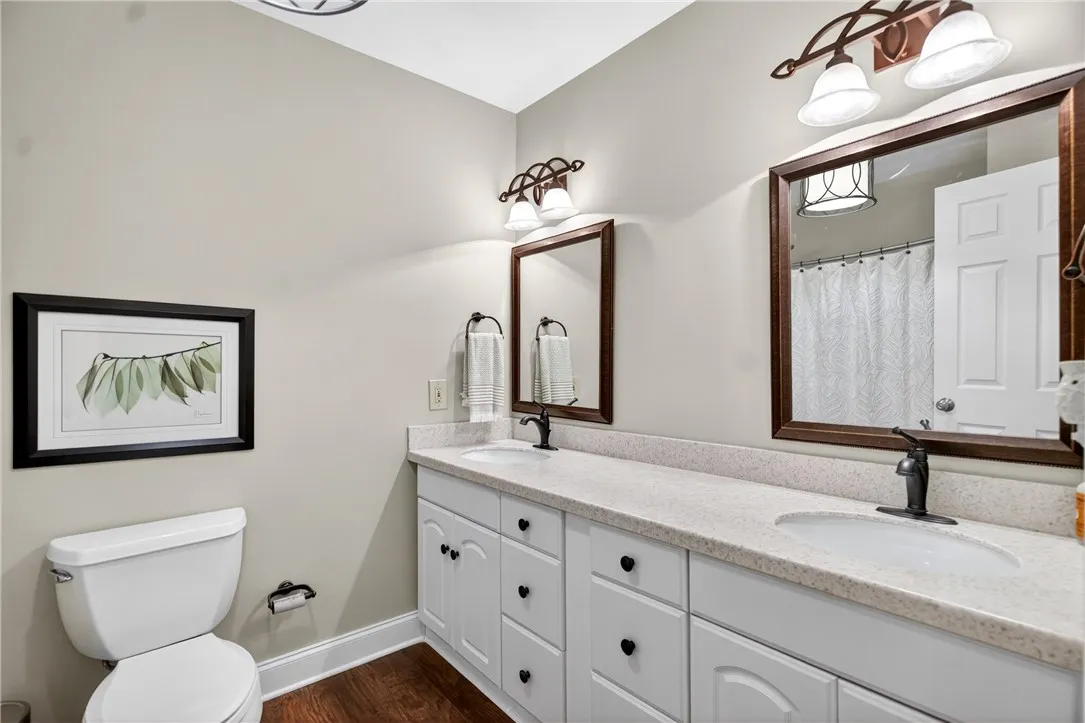 This bright bathroom features a spacious double vanity with ample storage and sleek fixtures.
