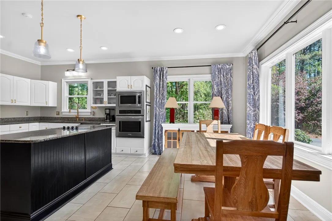This spacious kitchen offers a large island, modern appliances, and ample natural light.