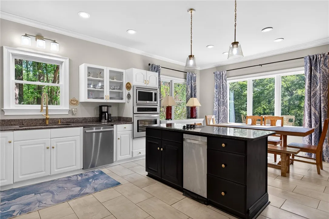 This spacious kitchen offers a blend of functionality and style, perfect for culinary endeavors and gatherings.