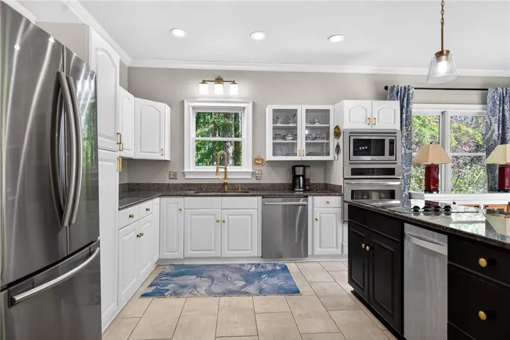 This bright kitchen features modern appliances and ample counter​​‌​​​​‌​​‌‌​‌‌​​​‌‌​‌​‌​‌​​​‌​​ space.
