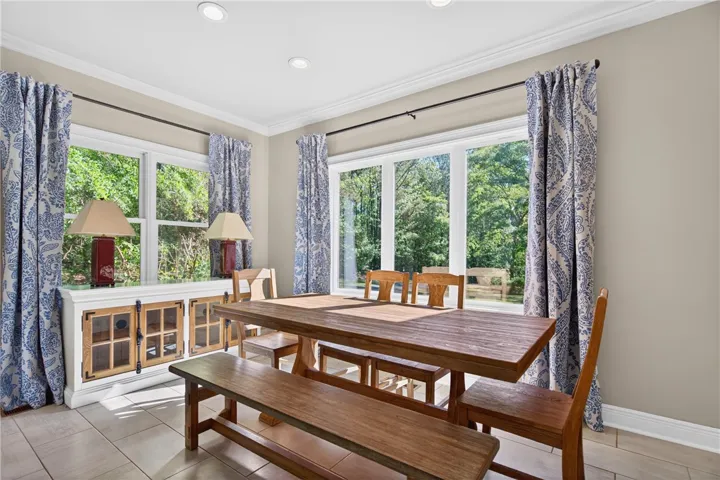 This bright dining area features ample natural light and a charming, inviting atmosphere.