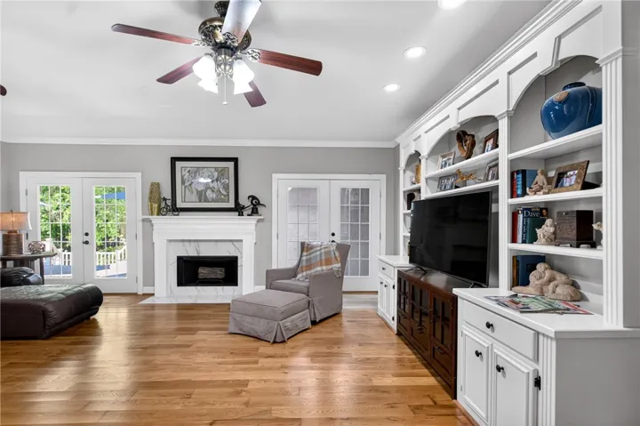 This inviting living space features warm hardwood floors and a built-in entertainment center.