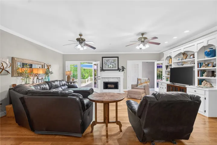 This bright living space features hardwood flooring and a classic fireplace, perfect for gatherings.