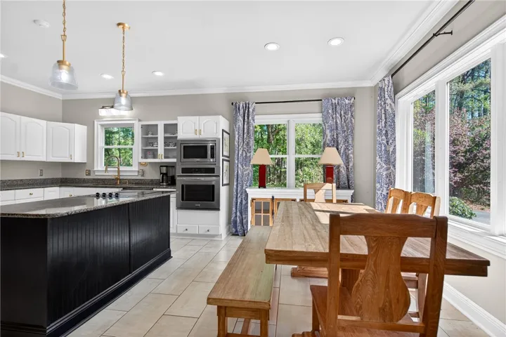 This spacious kitchen offers a large island, modern appliances, and ample natural light.