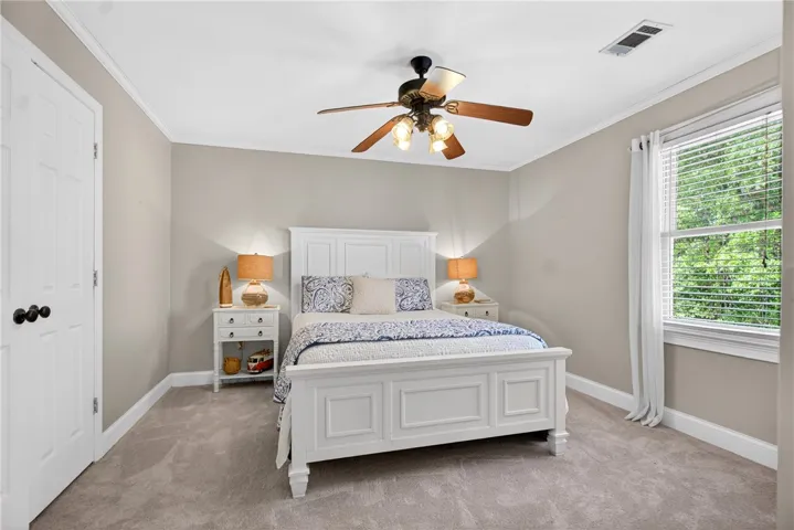 This inviting bedroom provides a comfortable retreat with ample natural light.