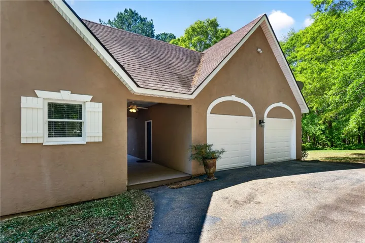 This house features a classic design with an inviting exterior and convenient garage access.