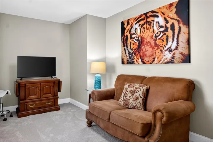 This versatile room offers comfortable living with soft carpeting and ample space.