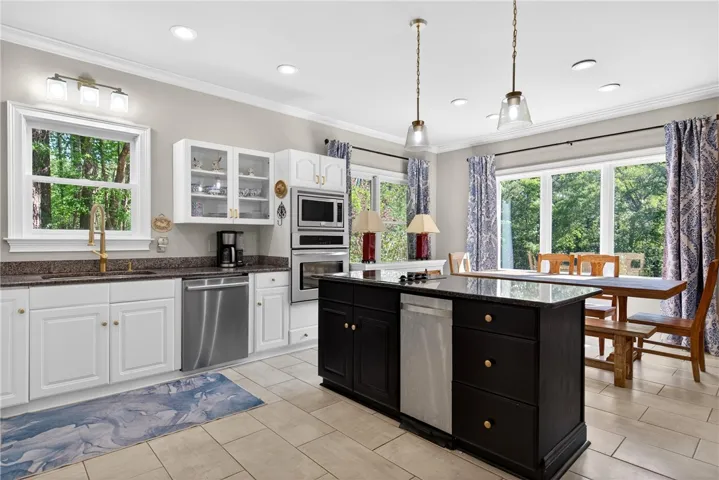This spacious kitchen offers a blend of functionality and style, perfect for culinary endeavors and gatherings.