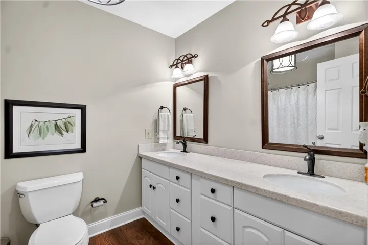 This bright bathroom features a spacious double vanity with ample storage and sleek fixtures.