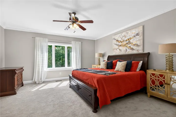 Relax in this peaceful bedroom retreat, offering natural light and ample space.