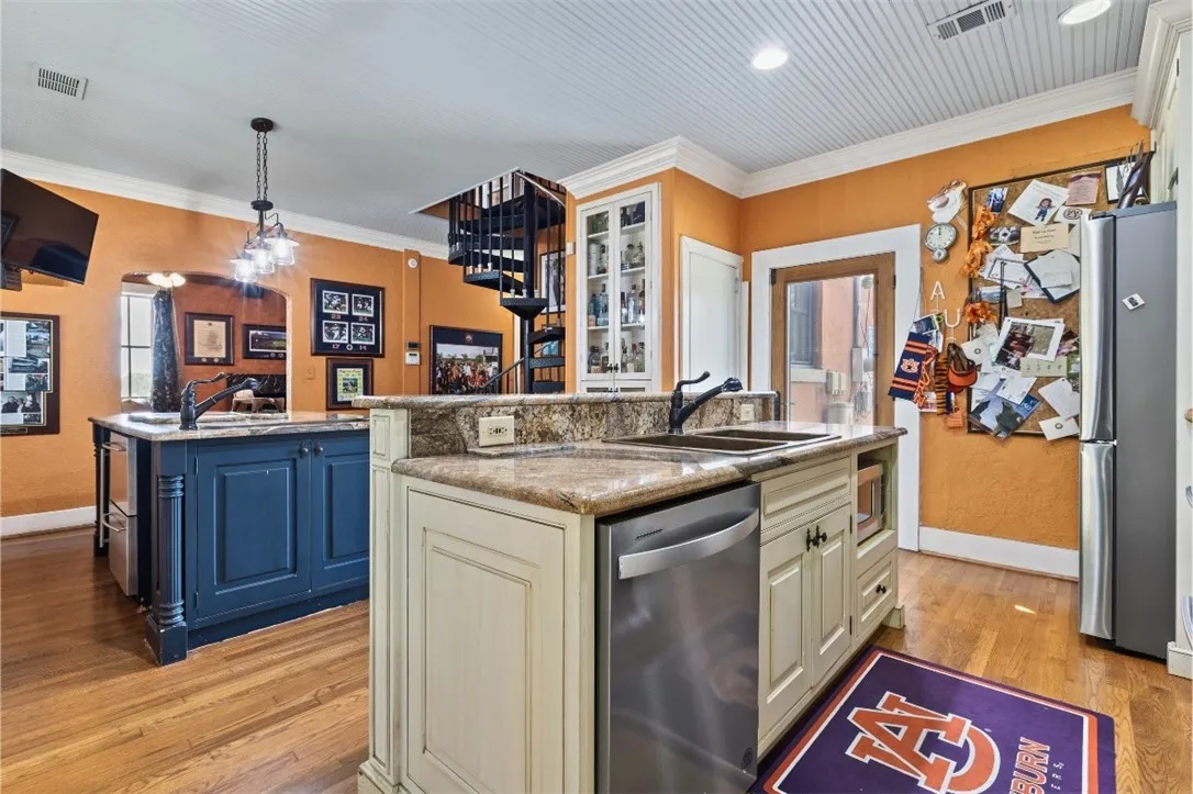 The second island features a beautiful copper sink, seating and a wine fridge.