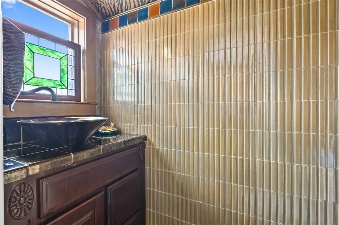 The half bath has unique tile work.