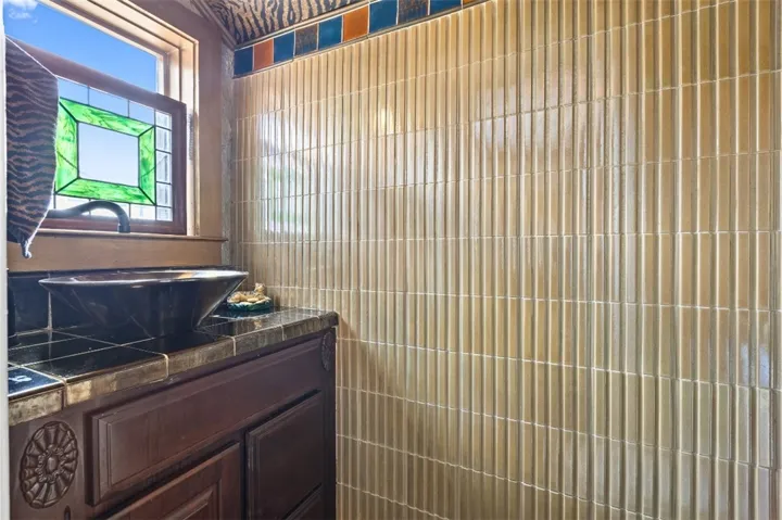 The half bath has unique tile work.