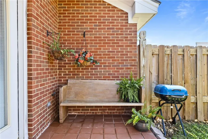This inviting porch offers a tranquil spot for relaxation and outdoor enjoyment as well.