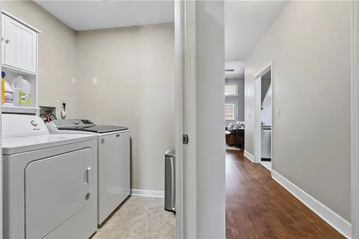 Dedicated laundry area offering practical convenience with essential appliances (neg) and organized storage. (Across from downstairs bedrm)