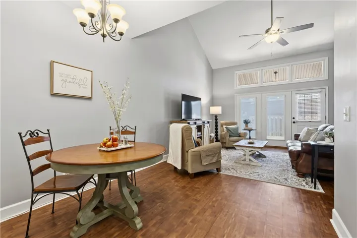This inviting space features vaulted ceilings and rich vinyl-wood flooring, perfect for comfortable living.