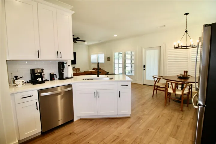 The black accents really set off the white cabinets, quartz countertops and white subway tiled backsplash.
