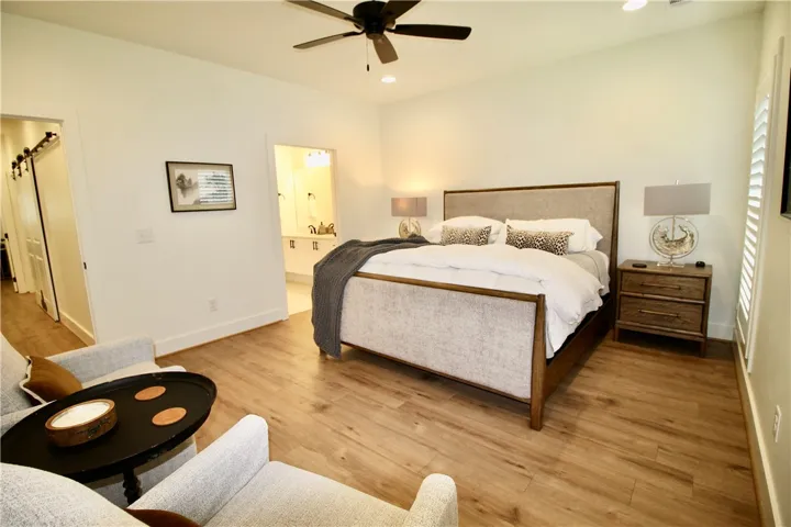 The primary bedroom is spacious enough for multiple pieces of furniture.