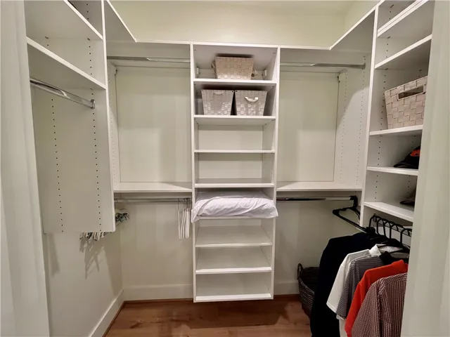 Primary bedroom closet with built-ins.