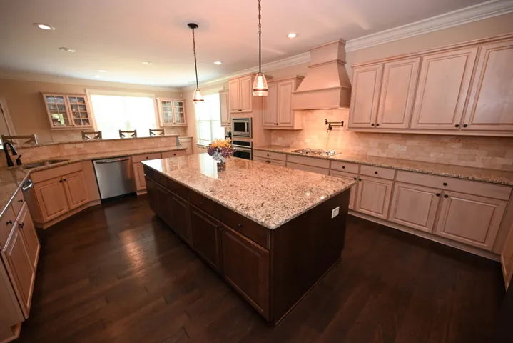 Flowing into the kitchen, you'll find stunning cabinetry, countertops and a large island.
